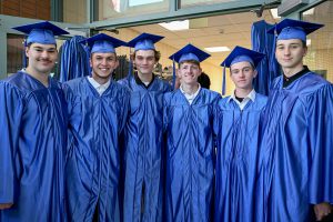 A group of CTE students are smiling for the camera before the graduation ceremony.