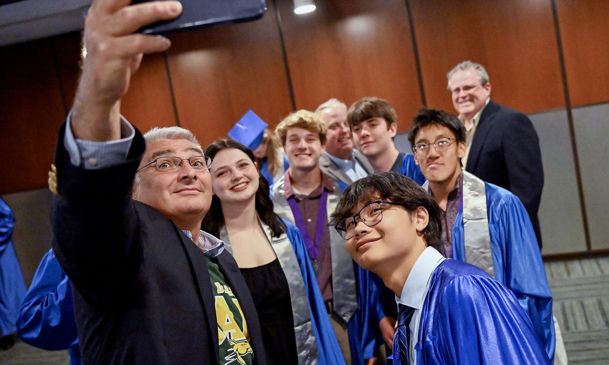 Graduates gather for a selfi.