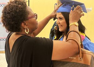 A woman helps a graduate with mortarboard prior to Capital Region BOCES Career and Technical Education Center's graduation ceremony at Empire State Plaza on Monday, June 10.