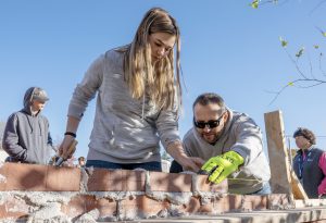 Megan Emerich, Junior at BHBL in Electrical Trades, learns masonry from Bricklayers and Allied Craftworkers Organizer Chris Tedford