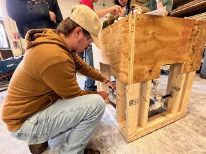 Student installs a pipe