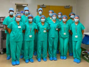 Students dressed in hospital garb standing in rows