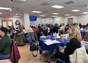 Counselors seated at tables in the dining room