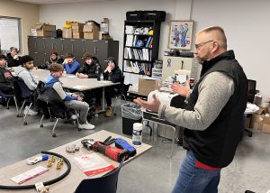 visitor speaking to students