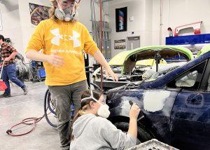 Students sands while another watches