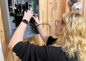 A female student wires a box