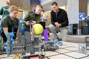 Two students playing with tech with Senator Jacoby Ashby