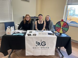 Attendees pose behind a table at last year's career fair