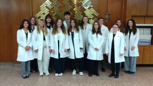 Class photo of students wearing white lab coats