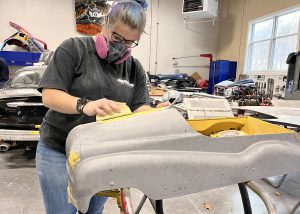 A student sands with a respirator