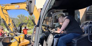 A student operates heavy equipment