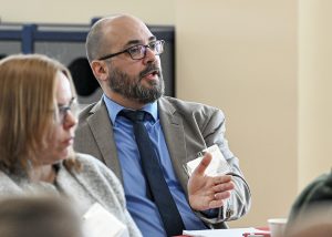 A superintendent asks a question while at a table